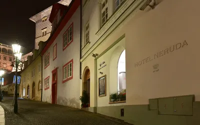 Design Hotel Neruda: the hotel facade on cobbled Nerudova street at night, Mala Strana, Prague